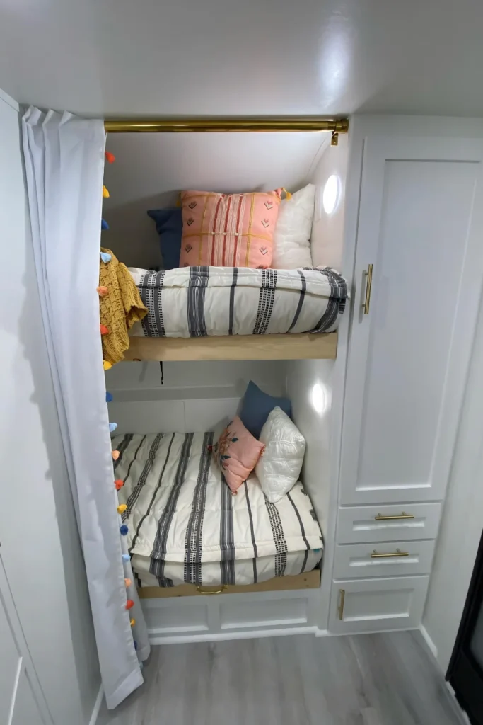 Brass Fixtures Elevate A Plain White Bunk