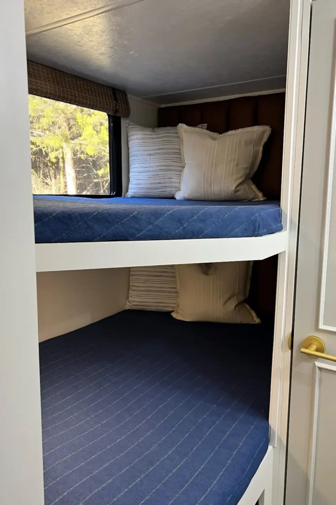 A Tufted Panel Upgrades A Plain Bunk Wall